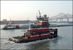 A tow boat moves along the Mississippi River in New Orleans.